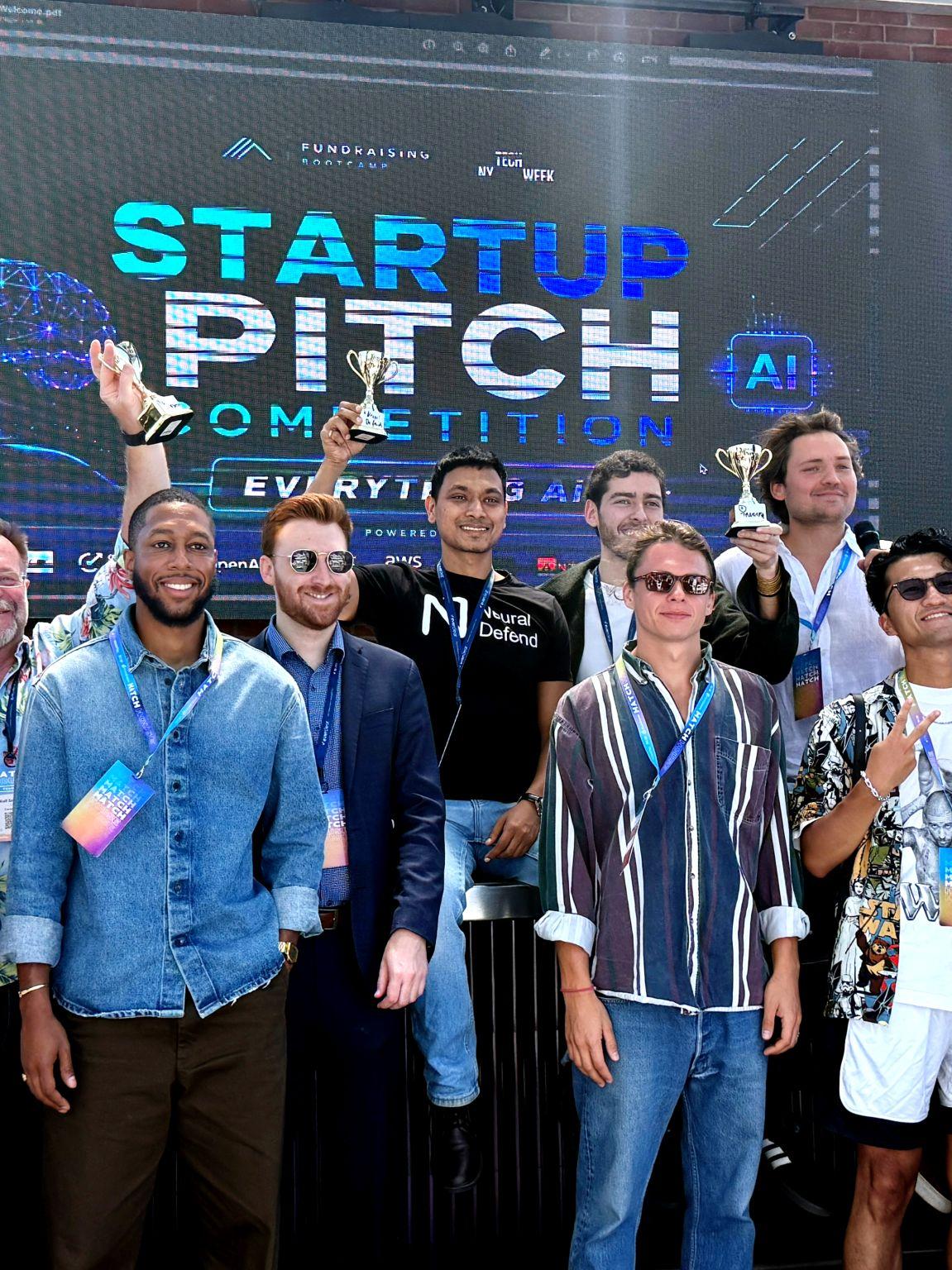 Piyush Verma of Neural Defend holding a trophy with other founders at the Everything AI Startup Pitch Competition